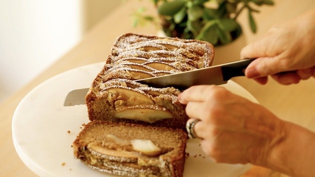 Slicing into baked spiced pear cake