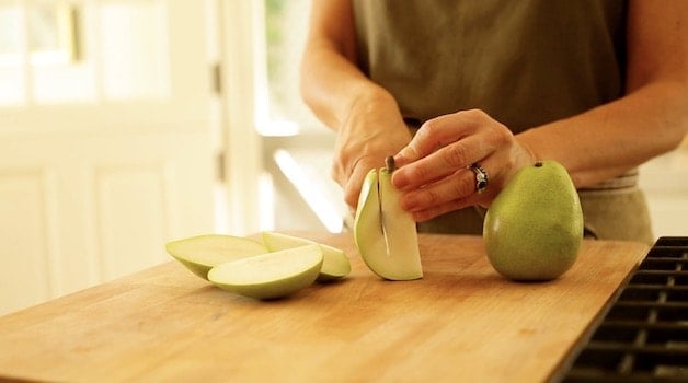 slicing hips off pears on a cutting board