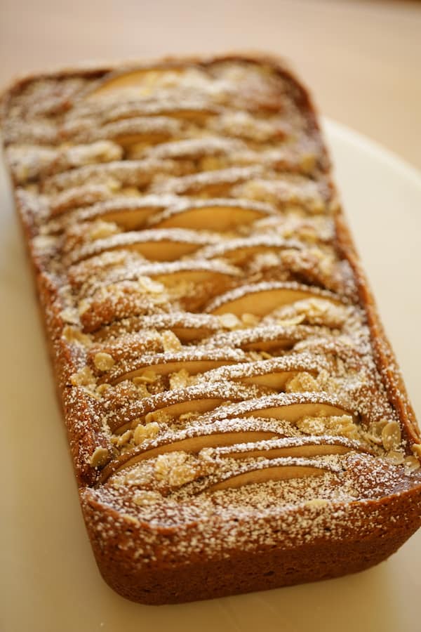 Spiced Pear Cake on a Cake Stand dusted with powdered sugar