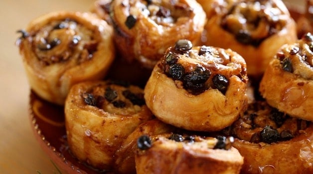 detail of pecans and raisins in a sticky bun