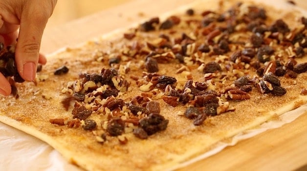 pecans and raisins and cinnamon sugar on a puff pastry sheet