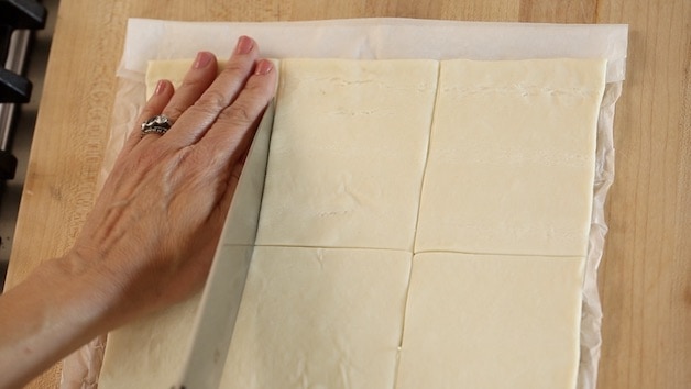 slicing puff pastry sheet into 9 squares