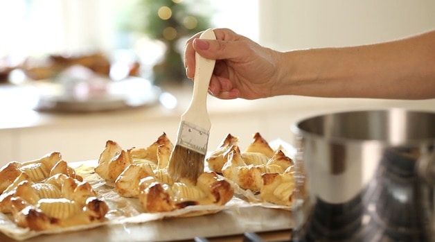 Brushing Apple Jelly on freshly baked apple pastries