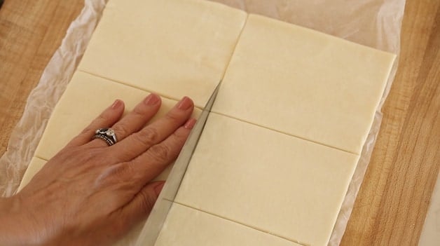 slicing puff pastry dough into rectangles