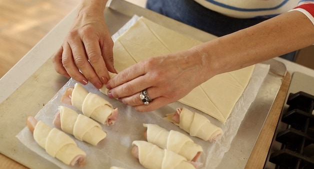Rolling ham and cheese croissants