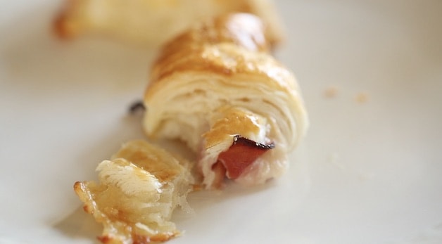 flakey interior of a croissant with ham and cheese