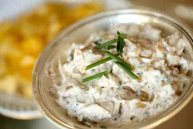 Sour Cream and Caramelized Onion Dip with Potato Chips in the Background