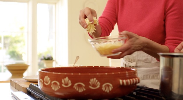 adding cheese to large terra cotta platter