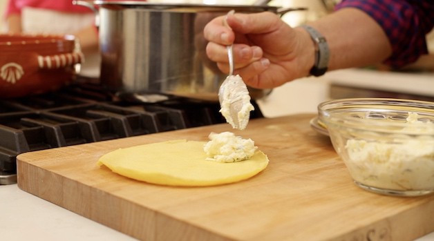 Filling a crepe with ricotta cheese