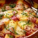 Manicotti with cheese garnished with basil in a round platter