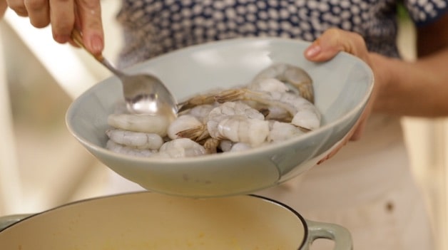 Adding raw shrimp to a pot