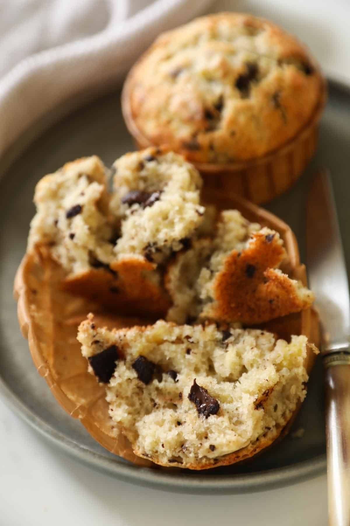 A muffin split open showing the light and fluffy texture and melted chocolate.