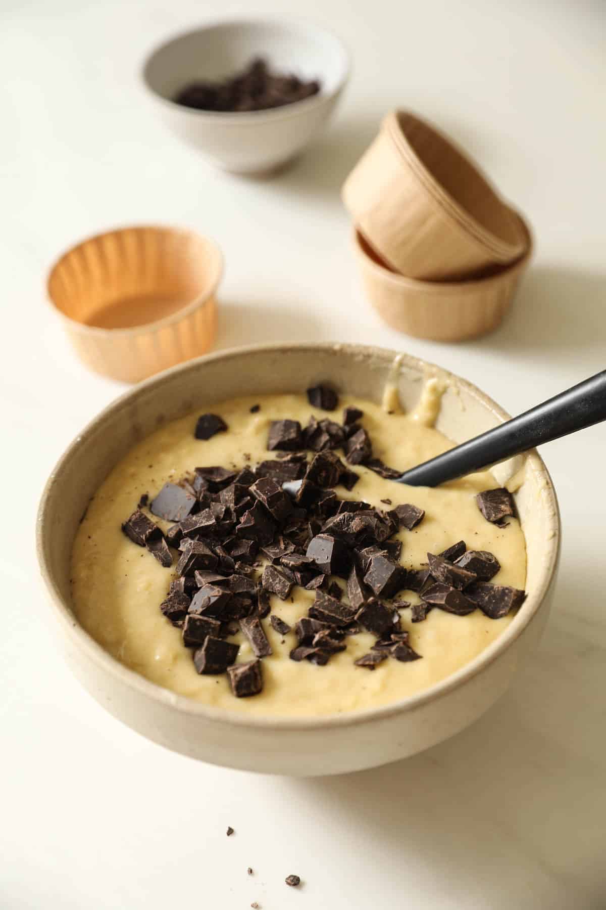 A batter Bowl with Chocolate Chunks stirred into it