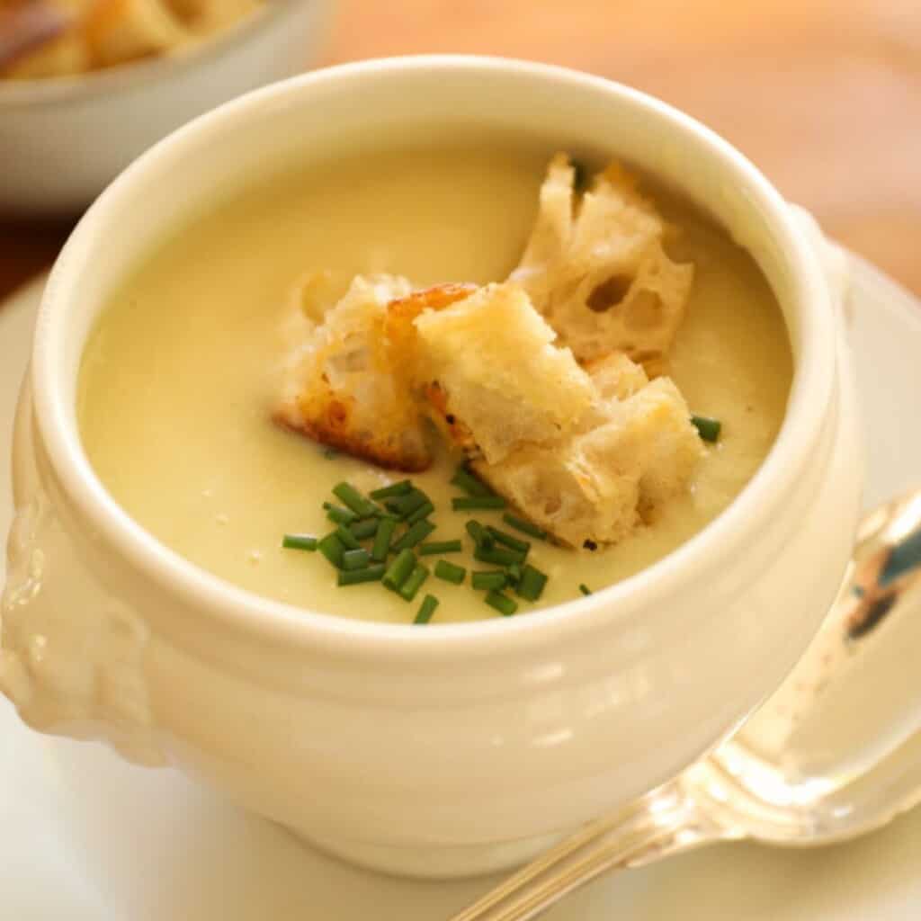 a tight shot of a leek and potato soup with chives and croutons