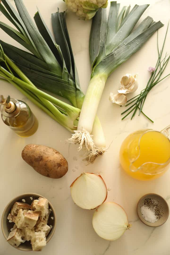 Chives, Potatoes, chicken broth, herbs and seasonings on a counter