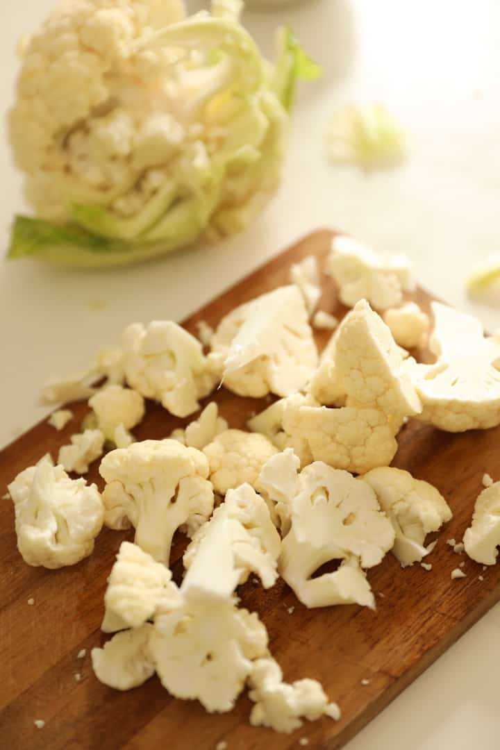 sliced cauliflower florets on a cutting board