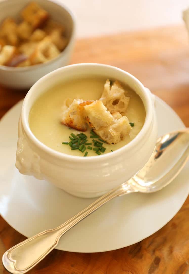 Leek and Potato soup in a bowl with chives and croutons