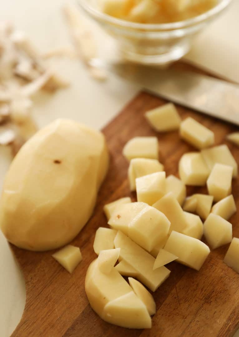 Potatoes cut into cubes on a cutting board