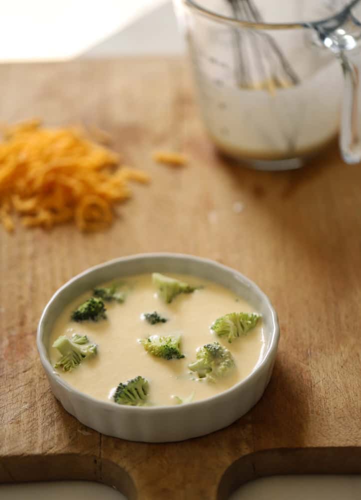 Custard filled ceramic quiche dish with broccoli.