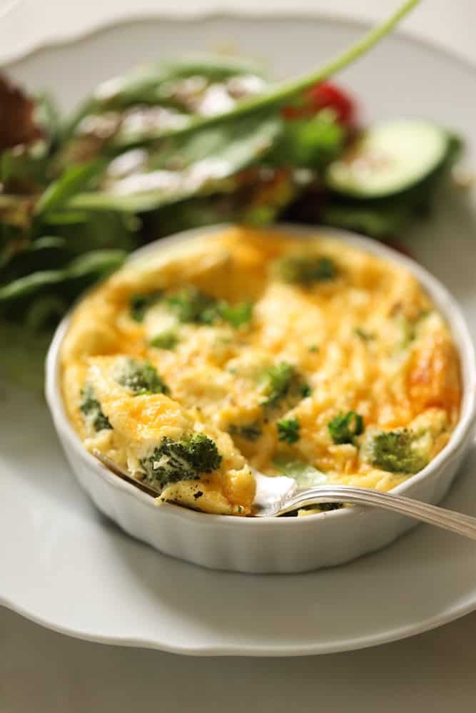 An air fryer quiche with a fork in it showing the interior texture.