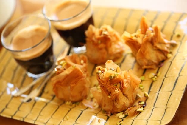 Baklava bites on a plate with coffee