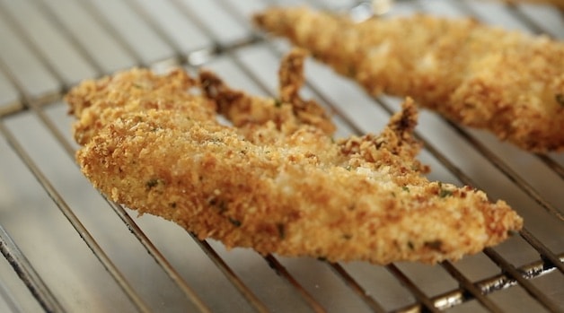 Crispy chicken tenfder on a rack