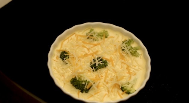 placing broccoli and cheddar cheese in the air fryer