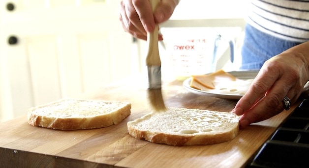 Buttering bread for a grilled cheese sandwich