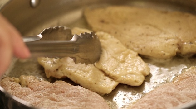 Chicken Breasts searing in a skillet