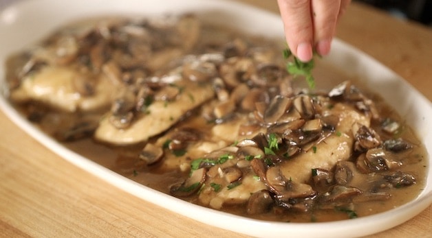 Chicken Marsala on a platter with fresh Parsley