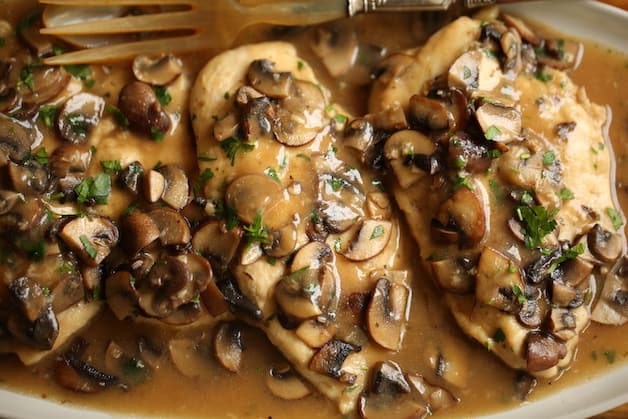 a plater of chicken marsala and mushrooms