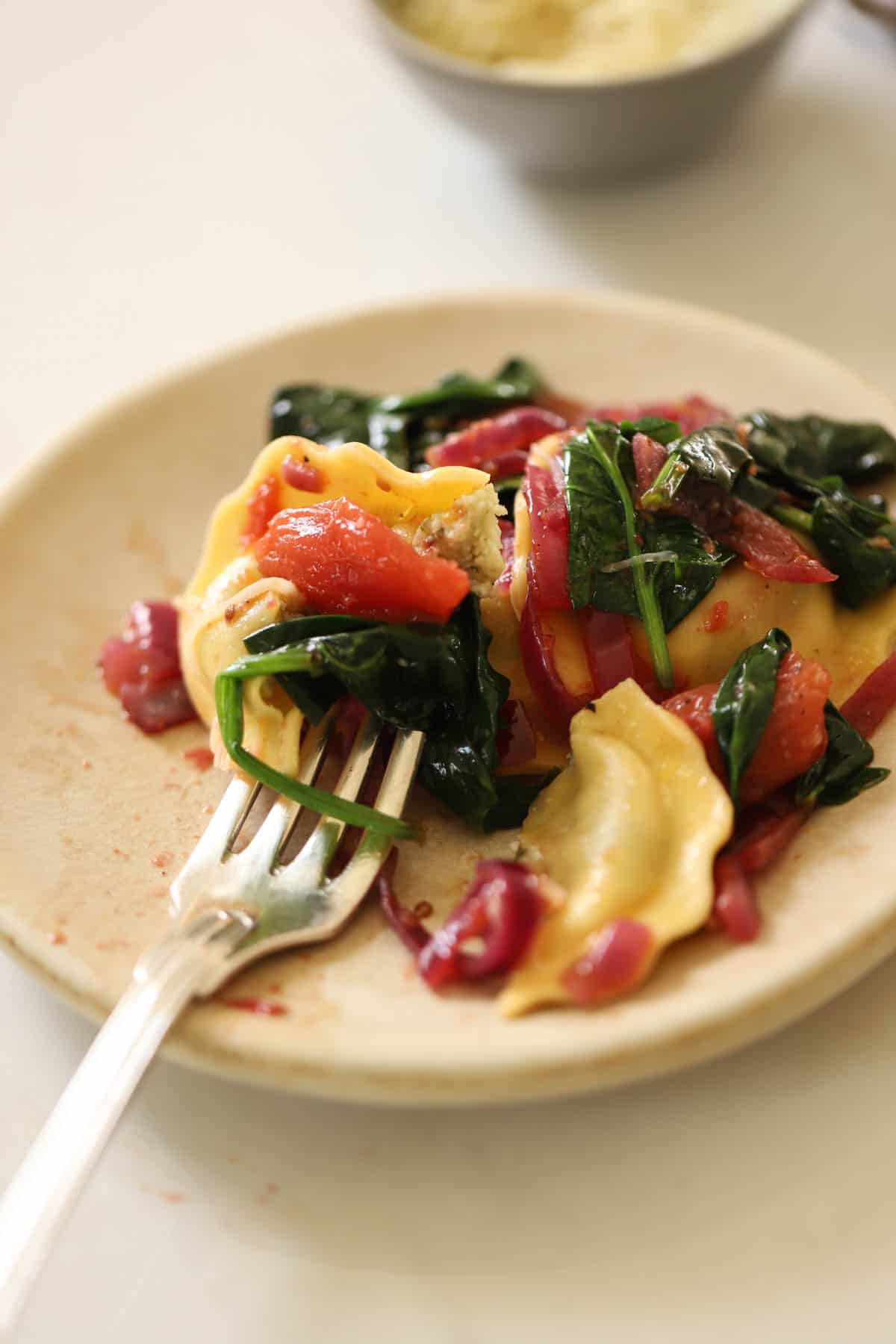 a serving of ravioli with veggies.