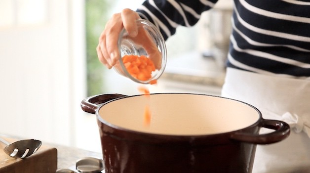 adding carrots to a large pot