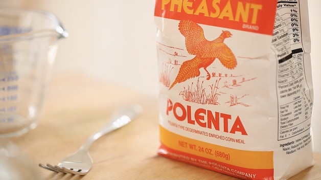 a package of polenta on a cutting board