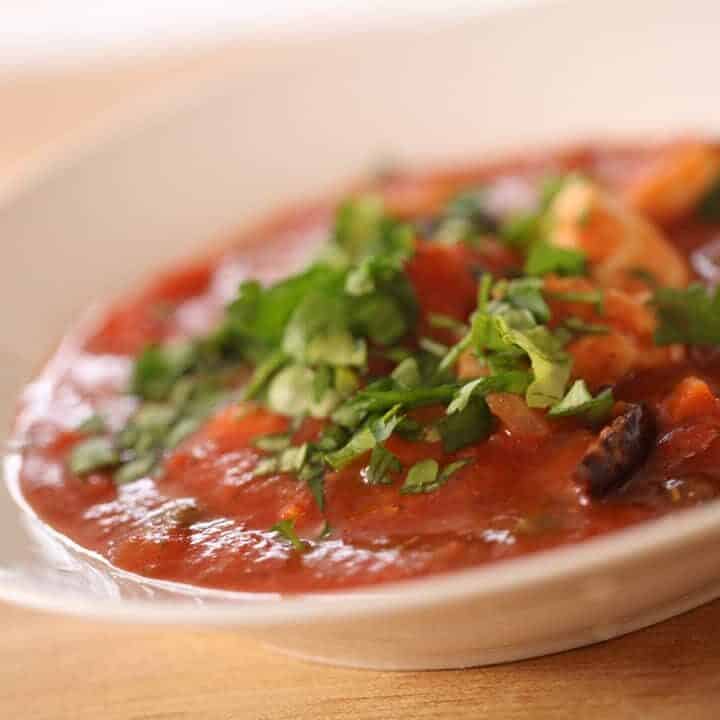 A close up of a bowl of Provencal Chicken Stew garnished with parsley