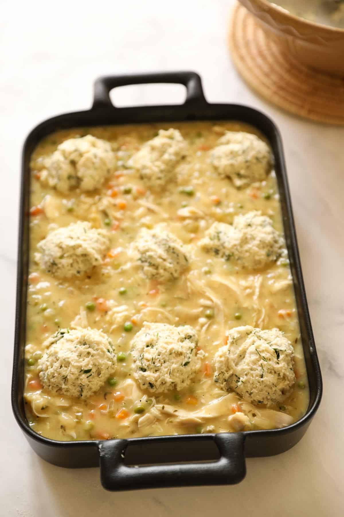 a chicken casserole topped with biscuit dough