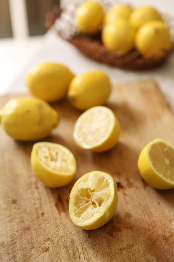 Sliced lemons on a board and in a basket.