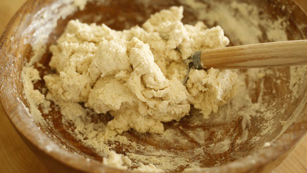 Biscuit dough in a wooden bowl sticky and wet