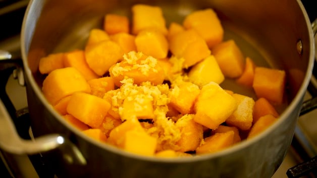 Frozen Mangos and grated ginger in a pot