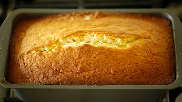 Coconut pound cake in a loaf pan cooling