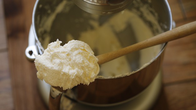 fluffy batter on a spatula resting on a mixer bowl