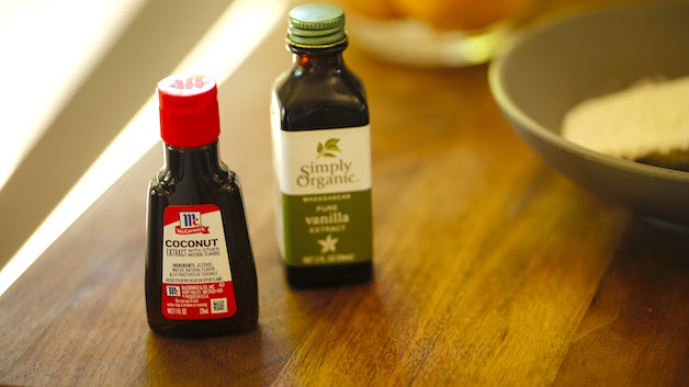 Coconut Extract and vanilla extract bottles on a cutting board