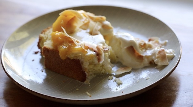 Pound Cake on a plate topped with melting ice cream and mango sauce half eaten 