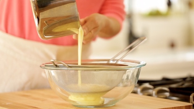 Straining Ice Cream Base through a sieve into a bowl