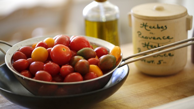 a strainer filled with cherry tomatoes 