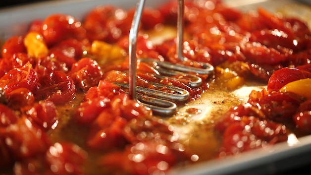 Mashing CHerry Tomatoes with a potato masher