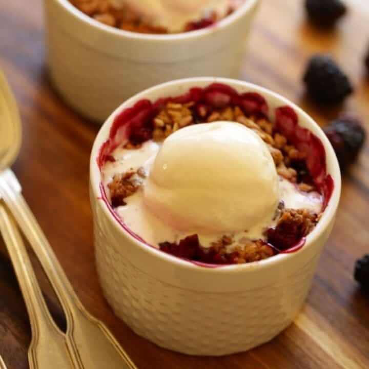 Blackberry Crumble in white ramekins with Ice Cream Melting