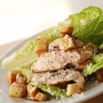 A Caesar Salad with Grilled Chicken on a Plate