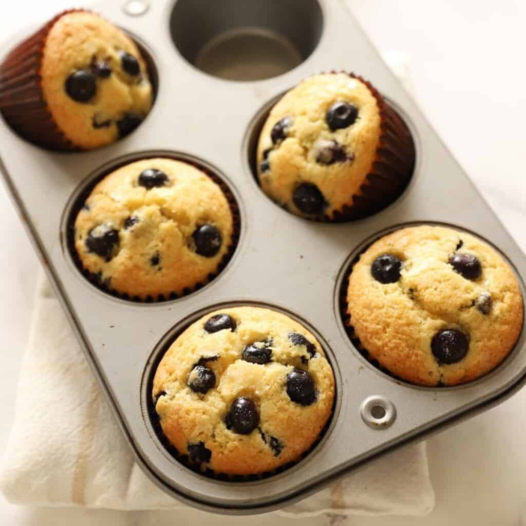 Blueberry Muffins in a jumbo muffin tin turned over on their sides