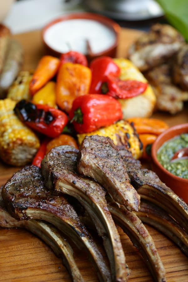 A close up of food on a wooden table, with Chicken and Mixed grill